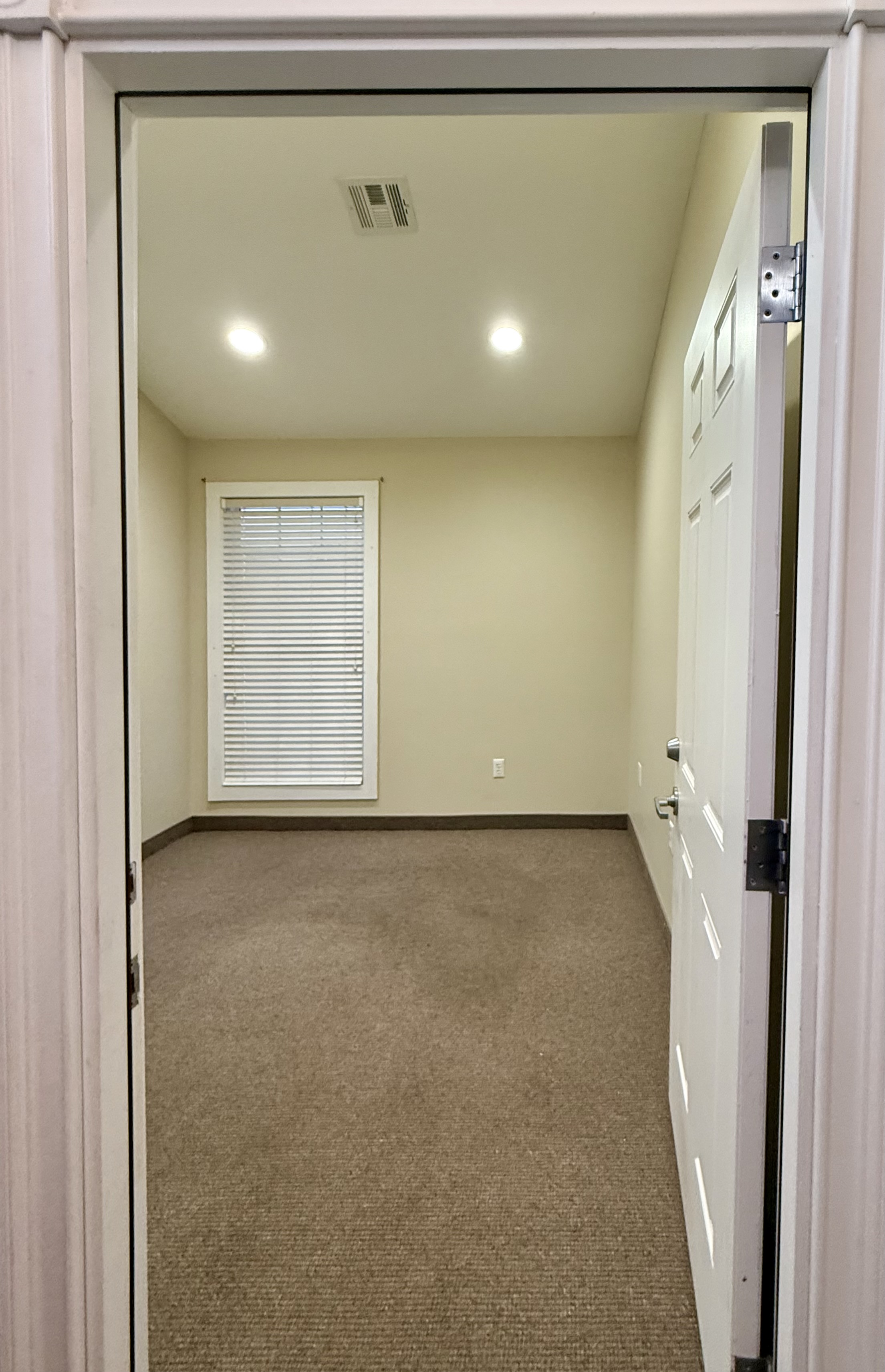 Suite 101 — view through doorway into private office with window
