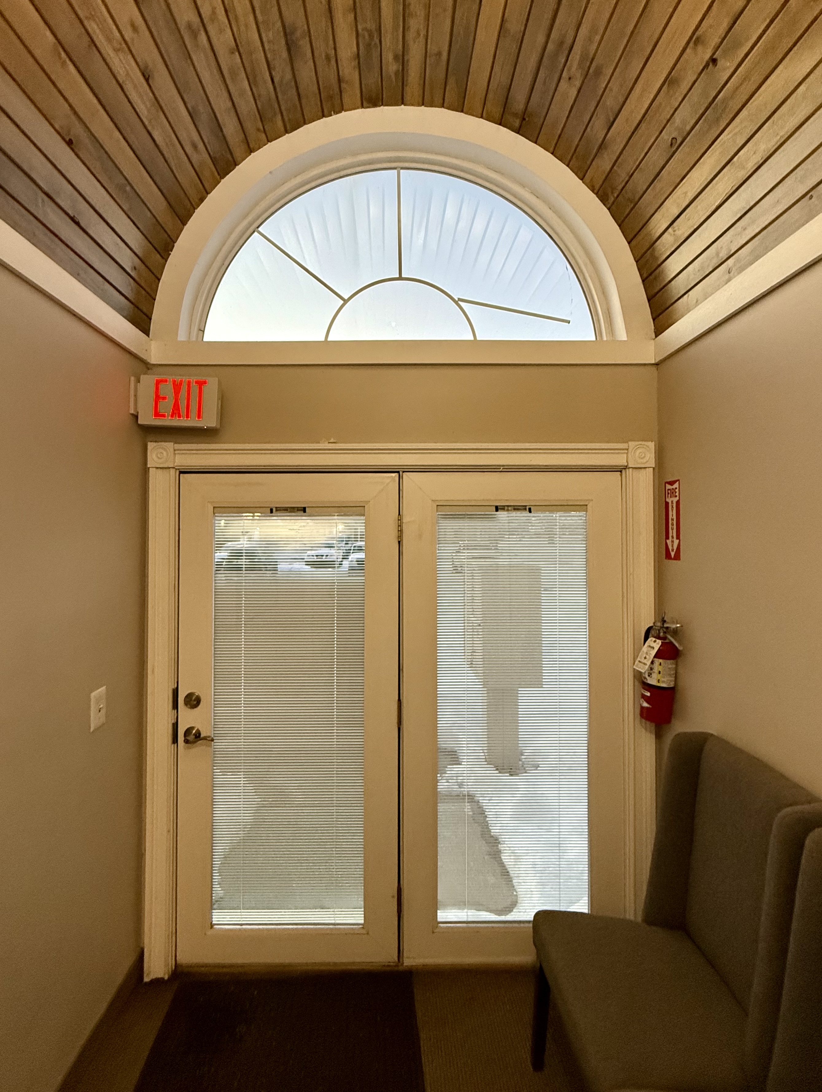 Arched-window entrance with wood ceiling at Cedar St office building, Olathe KS