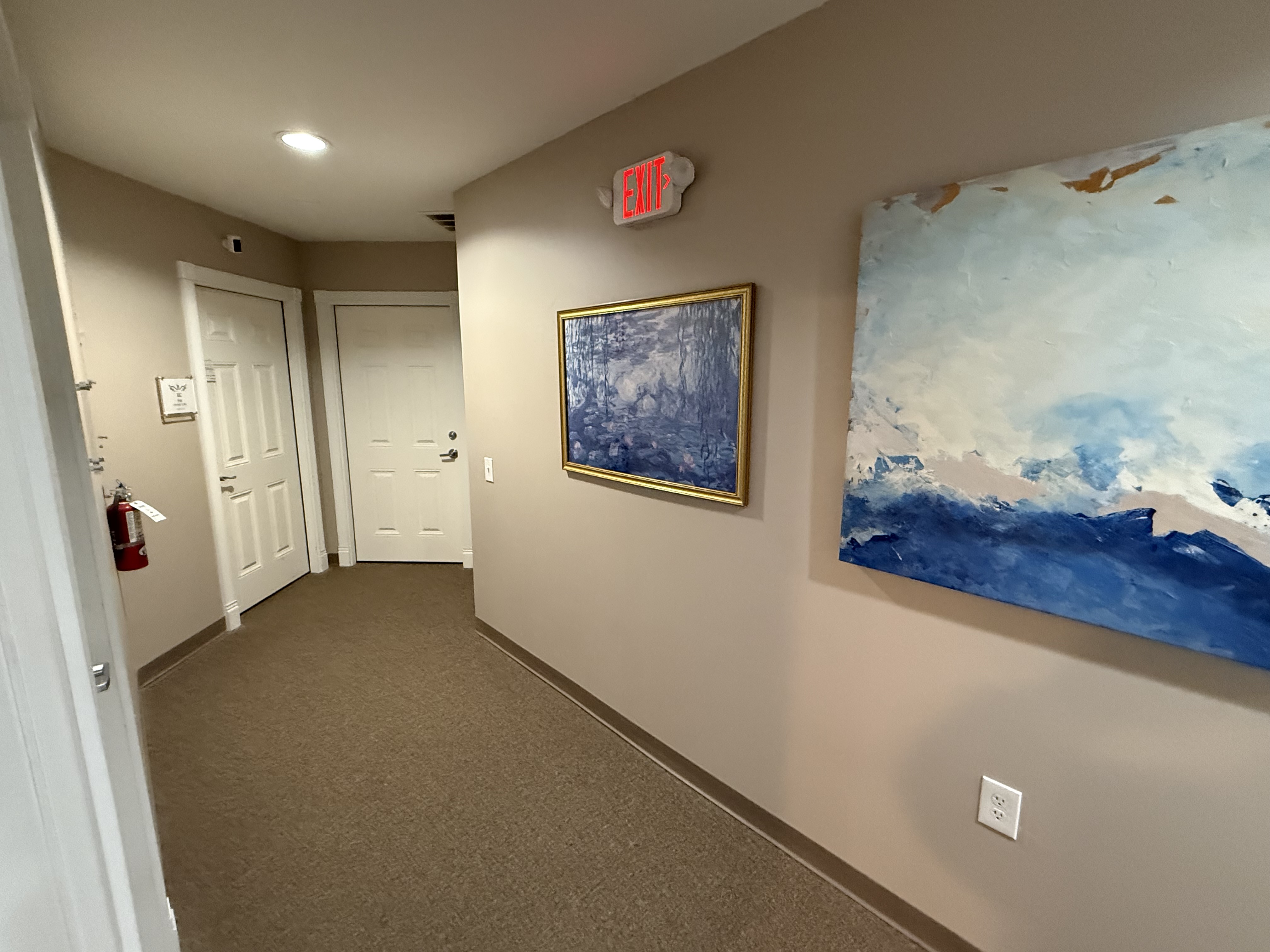 Common-area hallway with framed artwork at Cedar St building